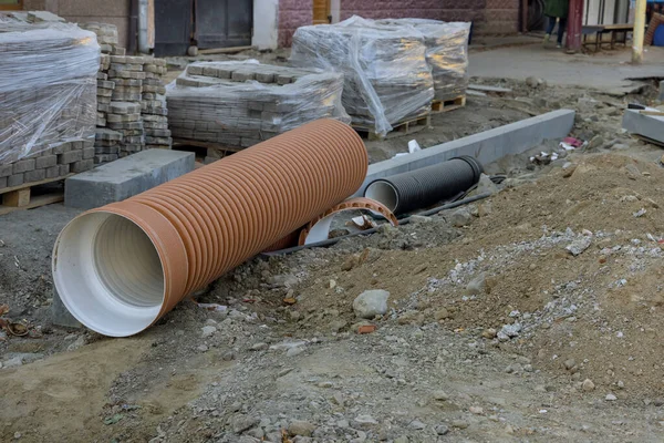 Pipe awaiting installation for laying the road reconstruction by repairing utilities — стоковое фото