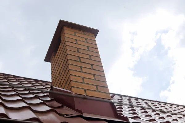 Chimney on of roofing materials red metal roof tile sheets — Stock Photo, Image