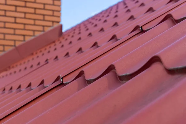 House with a red metal roof tile — Stock Photo, Image