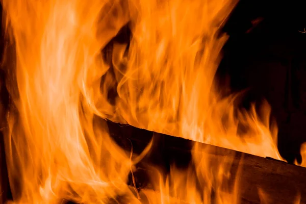 Closeup view on burning wood in a fireplace the home — Fotografia de Stock