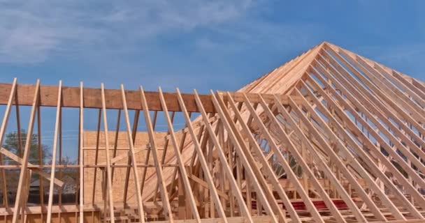 An aerial top view of stick built home under construction with wooden truss, post beam framework — Stock Video