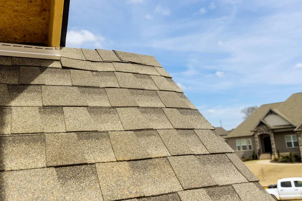 Aerial view the asphalt shingles roofing construction waterproofing for new house in covered corner roof shingles — Stock Photo, Image