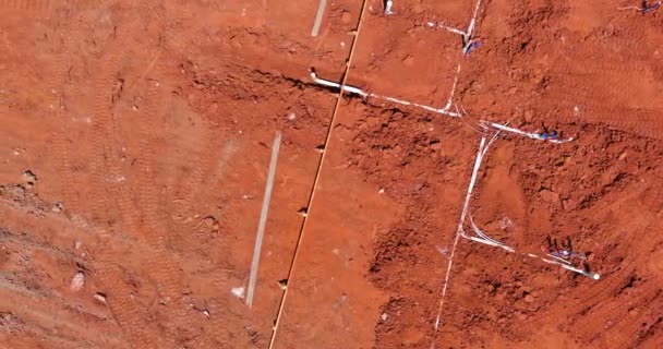 Laying water PVC plastic pipes in ground during plumbing construction site. — Vídeos de Stock