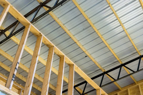 Construction site, steel structure is under construction warehouse hangar with metal roofing