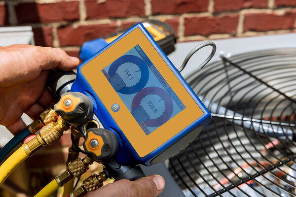 Air conditioner check service the technician repairing outdoor air conditioner unit