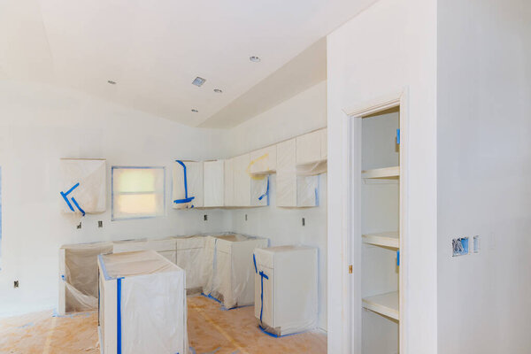 Finishing works in progress spray painting wall of paint a new kitchen