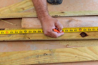 Marangozluk bir kalem ile çalışan işçi el kesmek için tahta uzunluğu ile ölçü.