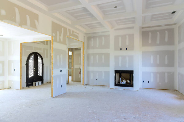 Finishing putty on empty apartment walls during renovation of a new house