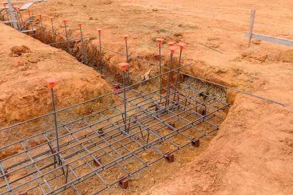 Foundation steel in a trench for house on construction site