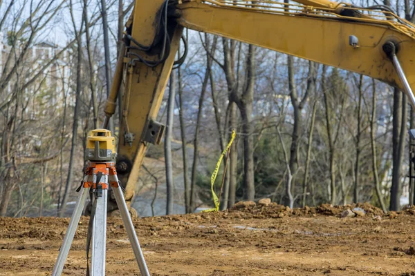 Measuring equipment like rotary laser levelers is used during road construction by the contractor on the construction site