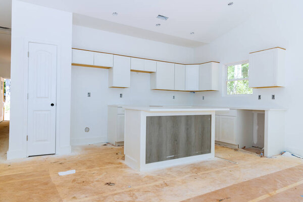 White kitchen wooden cabinets with home improvement view installed in a set of furniture under construction