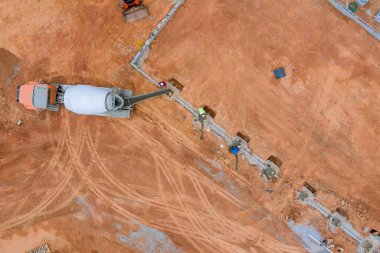 A concrete mixer truck was used to pour concrete columns to construct a new house an construction site