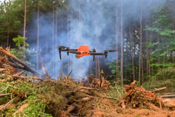 Drones are being used by fire services to monitor the fire as it moves through the trees of the forest with natural disaster