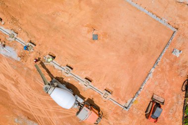 Beton bir mikser kamyonunun yardımıyla beton kolonlar döküldü. Bu hava manzaralı yeni bir ev inşa etmek için.