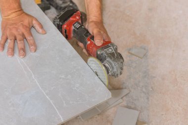 Açı öğütücü diski elmasla parlatır. İşçi, kesilen köşedeki fayansları yontmada kullanırmış.