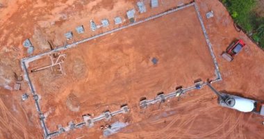 Aerial top view of concrete columns pouring on a construction site