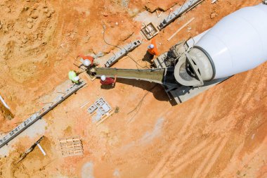 During construction of a new building, workers pour concrete columns in construction site
