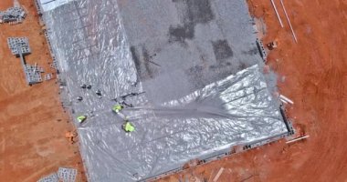 A barrier plastic barrier is installed before concrete is poured into the foundation of structure