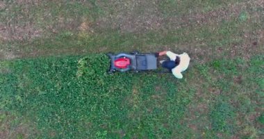 Using a lawn mower on green lawn with grass cutting is garden care tool you need to use to take care of your garden