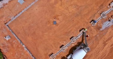 Using a concrete mixer truck, concrete columns were poured to build a new house an aerial top view