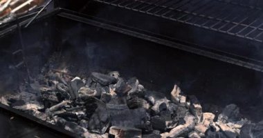 On the hot BBQ grill, mixed American barbecue food is grilled on burgers beef roasts