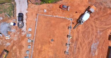 A concrete mixer truck was used to pour concrete columns to construct a new house an construction site
