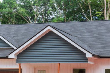 Modern of asphalt shingles roof covered to the new house with under construction site