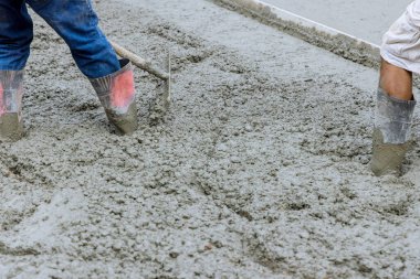 During construction of driveway at a construction site, wet concrete was poured into the mix