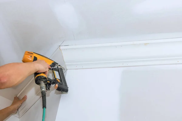 Using Air Nail Gun Carpenter Installed Crown Molding Corners Ceiling — Zdjęcie stockowe