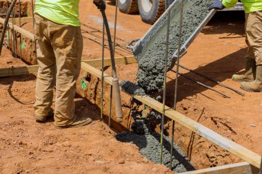 Concrete trenches are poured as foundation for a house, and are used as the foundation in construction area