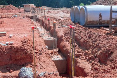 Concrete trenches are usually poured as foundation for a house by process of pouring concrete trenches