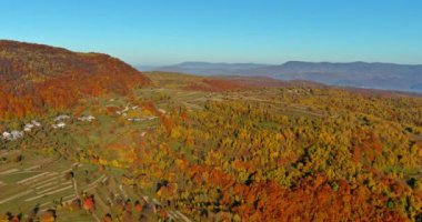 This is view from a panoramic mountain panorama in the autumn of forest near village