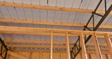 In a frame warehouse, the roof is covered with panels of roofing that are made metal