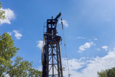 On private plot of land, a portable hydraulic water well drilling rig with water extraction