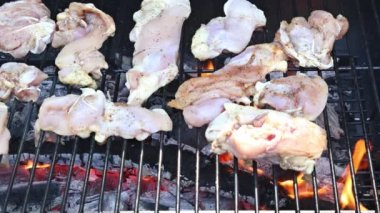On a charcoal grill, delicious dishes are prepared from BBQ fried chicken meats