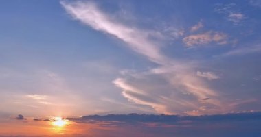 The sunset was spectacular above clouds, with the sky being blue, the sun shining and sunbeams in the distance