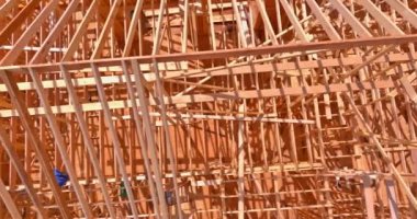An aerial view of a new construction with timber frame beam framework and timber trusses