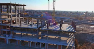 Multi-storey apartment building is being constructed using tower cranes that can reach heights as the work progresses along the building