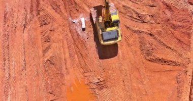The excavator digs a pit for the connection of the storm sewer pipes while laying underground storm sewer system