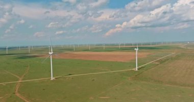 On wind electricity farm in Texas, U.S., one can see a row of windmill turbines which produce renewable green energy.