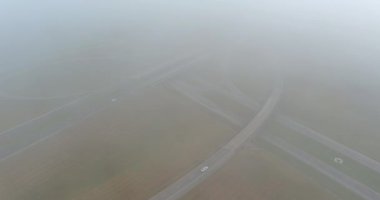 An early morning panorama dense fog surrounding a bridge that crosses the US 65 Highway near Satsuma, Alabama, United States of America, in early morning.
