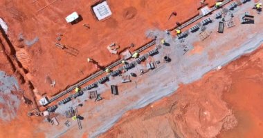 As a mason man is mounting a wall of aerated concrete blocks, he was laying for the wall
