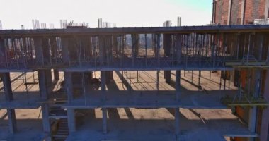A multi-storied apartment building is being constructed along the way, is still in progress on building works on construction site