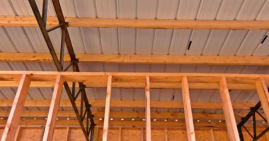 It is common to find roofing metal panels covering the roof of a warehouse that is constructed of under construction frames