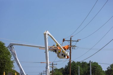 As a result of the storm, electrical workers are working in electric power pole maintenance industry to repair damaged power lines.