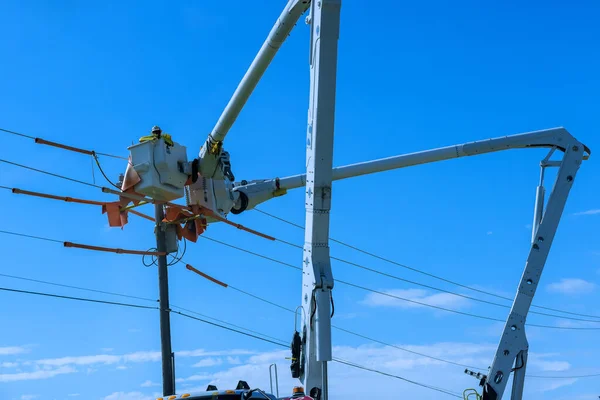 As a result of storm, electrical workers in the power pole maintenance industry were hired to repair damaged power lines.