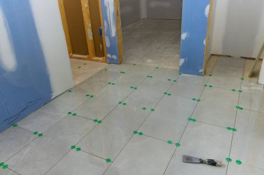 Process of building a new home, the bathroom is laying being tiled with ceramic tiles installed