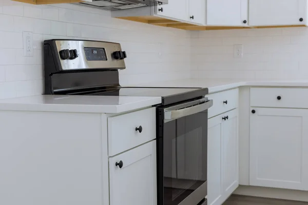 New home in a installing kitchen appliances as well white kitchen cabinets