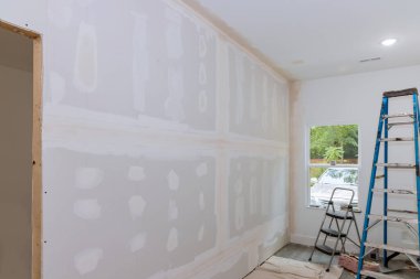 With the completion of plastering drywall newly constructed house is ready for painting clipart