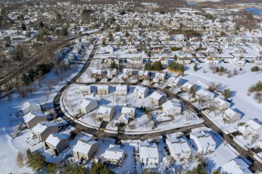 Bölgeyi vuran şiddetli kar fırtınası sırasında New Jersey 'de küçük bir kasabadaki yerleşim yerleriyle çevrili birçok binanın çatılarında kar vardı.